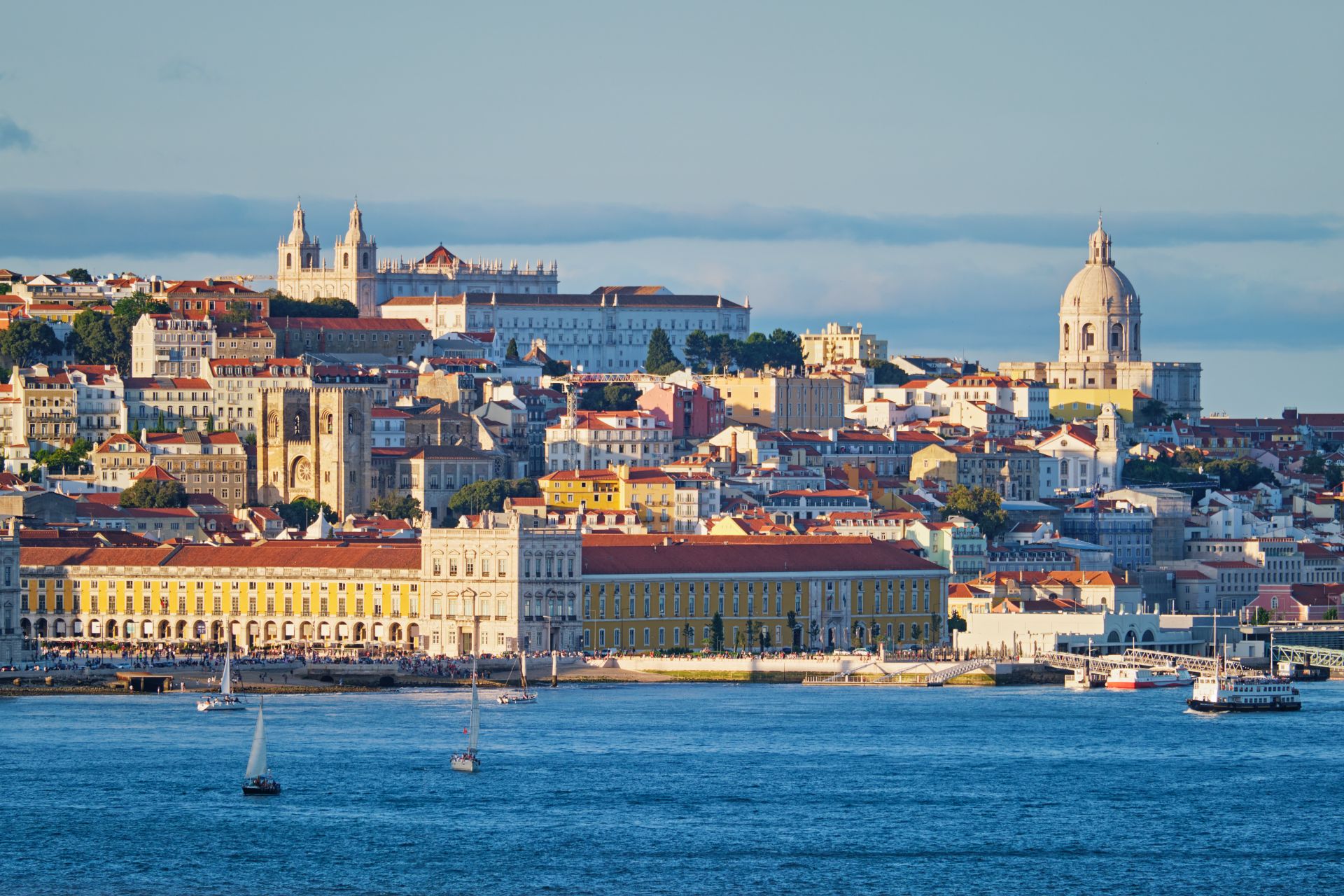 View of Lisbon view over Tagus river with yachts and boats on sunset. Lisbon, Portugal