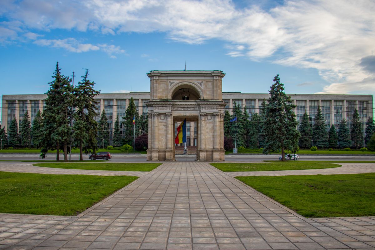 Triumphal Arch of Chisinau and the Government house under the sunlight in Moldova